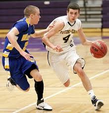 Senior guard Tommy McHale of Totino-Grace High School in Fridley tries to dribble past sophomore guard Kyle Kalivoda of Wayzata High School during Game 2 of ... - WEB-TG-vs-Wayzata