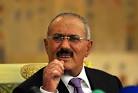 Below, Saleh during a news