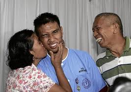 PROUD PARENTS Bemedalled Cadet First Class Alfonso Aviles gets a kiss from mother, Vangie, and a big smile from his father, Rodolfo, a retired Marine ... - cadet1