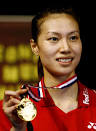 Xie Xingfang of China holds up