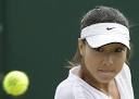 China's Zheng Jie watches the ball as she returns to Hungary's Agnes Szavay,
