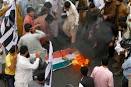 JuD burns, stomps on tricolor in Pakistan to protest MFN status to ...