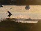This chap, dressed in denim shorts and a collared shirt, was surfing on a - via Daymix