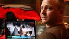 Robert Vos watches footage of