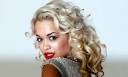 Rita Ora dives on to a sofa,