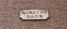 Old style street name high up on a wall of building on Robbins Lane, - via Daymix