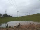 High voltage electric field. Looking east way from E1 elec sub station. - via Daymix