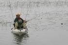 Man in white canoe casting - via Daymix