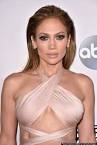JENNIFER LOPEZ Wows On AMAs Red Carpet In Ivory Bondage Dress