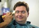Barber Tom Holguin brushes