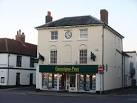 Christmas decorations are already in evidence above the estate agent's - via Daymix