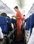 File:Garuda Indonesia Flight Attendants Serving Refreshment.jpg ...