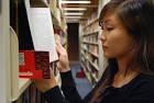 Sheung-Yi Wong, a senior math/statistics major, looks at a book flagged with ... - BannedBooks-SheungYiWong_lg