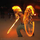 fire dancer with fire swords   burning man 2006