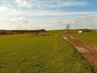 Aries Knowes. Farm track by the steading and view to Drumbreach Hill ahead. - via Daymix