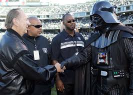 Raiders owners Al Davis shakes hands with Buffalo owner Ralph Wilson before the game.