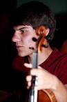 Behnam Arzaghi, 18, sits with