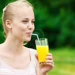 outdoor fitness exercise - 10283522-young-woman-drinking-orange-juice-after-outdoor-fitness-exercise