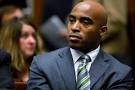 player Tiki Barber listens