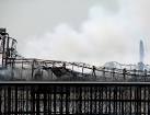A closer view of the smouldering Grand Pier remains. - via Daymix