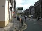 at the junction with Leith Street and opposite the old Head Post Office. - via Daymix