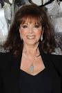 Jackie Collins poses backstage