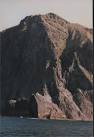Sgeir Mac Reigh Lochlainn in the foreground with the huge bulk of Soay - via Daymix