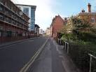 The brick building on the left-hand side of the street with the pointed - via Daymix