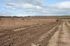 Open land, recently ploughed, south of the Elliot Water, which is in a dip - via Daymix