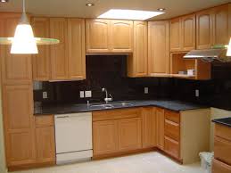 Maple kitchen cabinets, maple hardwood floors, and granite 