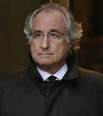 Bernard L. Madoff (R) leaves