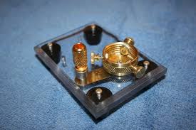 A brass strip makes electrical contact between the binding post and the ...