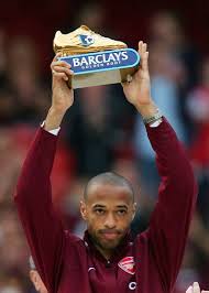 Arsenals Henry holds aloft