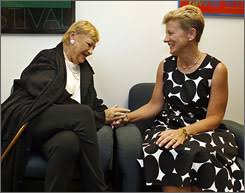 Mary Travers, left, talks with