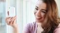 Closeup of pretty happy young woman using mobile phone - 2417924
