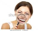 Funny Woman Smiling And Show Teeth Through A Magnifying Glass Over ... - stock-photo-funny-woman-smiling-and-show-teeth-through-a-magnifying-glass-over-white-background-113866201