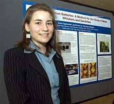 Anna Cyganowski stands next to her poster about metal whiskers and dendrites - 178472main_Cyganowski