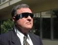 Retinal implant recipient Dean Lloyd wears his video glasses outside his law ... - vision_photo