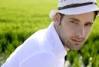Stock Photo - Mediterranean young latin man relaxed on wood pier white hat - 7992766-mediterranean-man-portrait-white-hat-in-green-meadow-rice-field