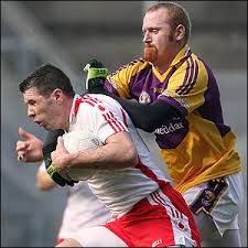 Sean Cavanagh of Tyrone comes under pressure from Wexford opponent Brendan Doyle during the All-Ireland semi-final - _44974759_cavanagh_doyle