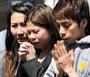 Matt Rourke /AP Tina Nguyen, center, prays with relatives of shooting ... - large_bing