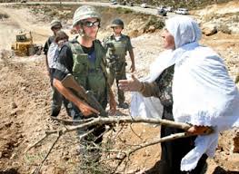 يا اشرف النساء اسمحي لي بقبلة على يديك September_27_2004_Israeli_soldiers_stop_a_Palestinian_woman_on_her_confiscated_land_Photo_by_Nayef_Hashlamoun