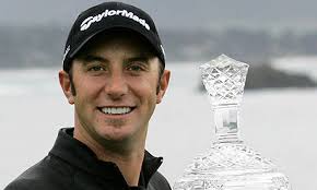 Dustin Johnson holds up his