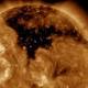 NASA is monitoring an enormous dark region spreading across the surface of the sun 