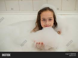 bath child girl|Two young females bathe a baby girl in a bowl in a remote village in North  Thailand Stock Photo - Alamy