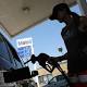 Exxon Mobil profit and revenue rise as the oil giant takes $2 billion impairment 