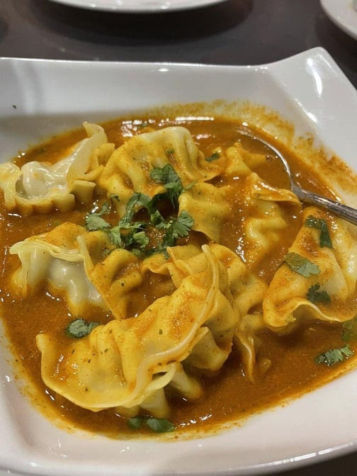 Bombay to Kathmandu Kitchen,Curry Pizza and bar by null