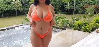 Stunning babe with big tits stripping off her bikini outdoor jpg x Bikini tits