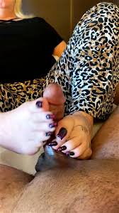Sexy mature woman in the pose shows her feet video jpg x Mature footjob milf