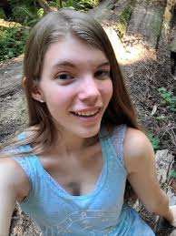 young selfies|Smiling young woman taking selfie in city stock photo